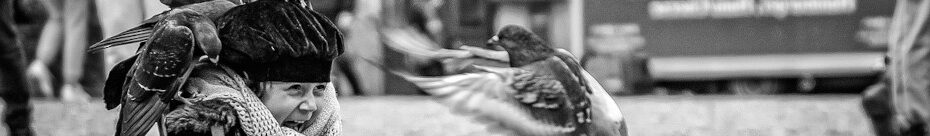 Image of a toddler feeding pigeons CC0